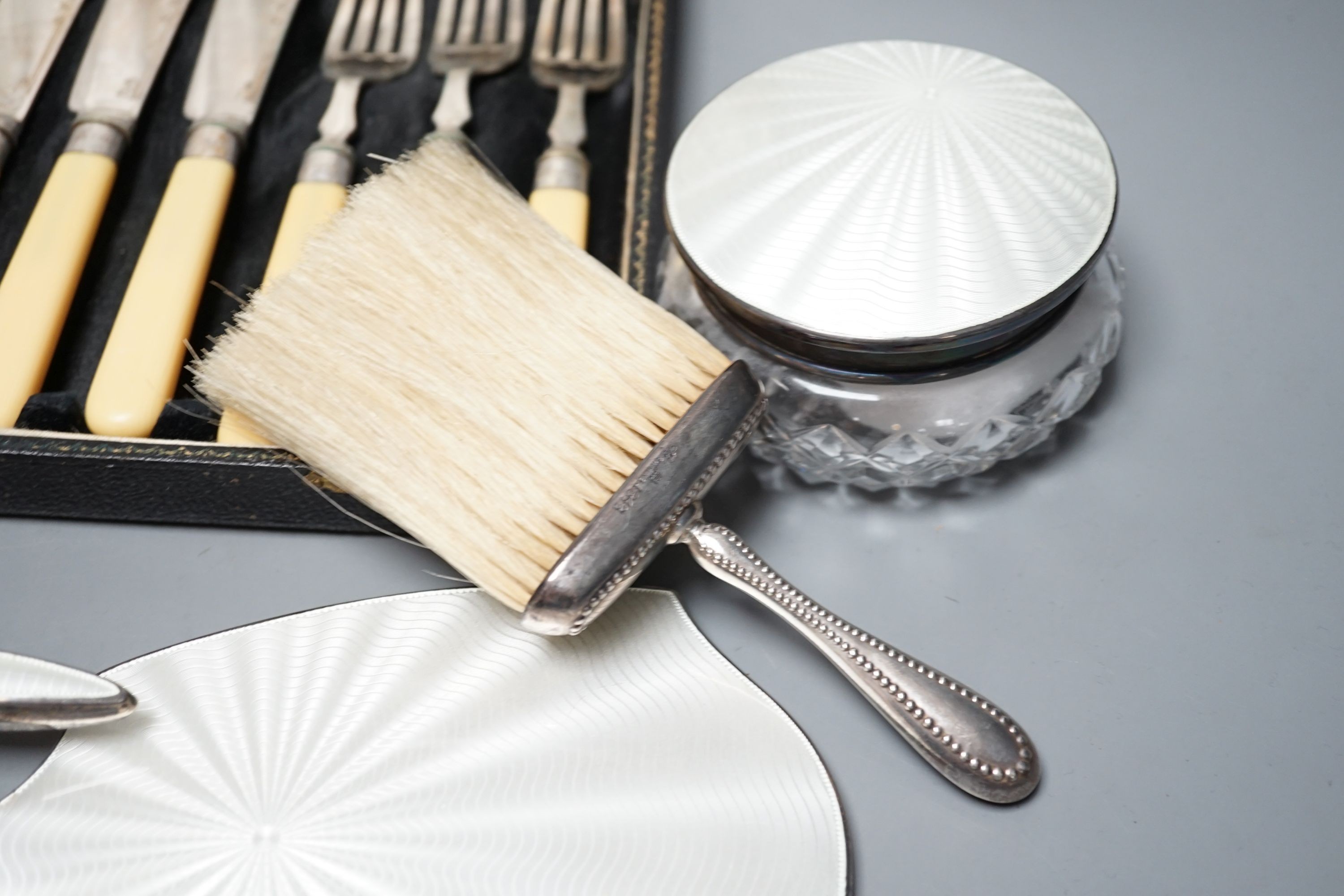 A mixed collection of sundry English silver to include unboxed flatware, a cased set silver teaspoons with tongs, further boxed cutlery including plated a four piece silver and enamel mounted glass dressing table set (en